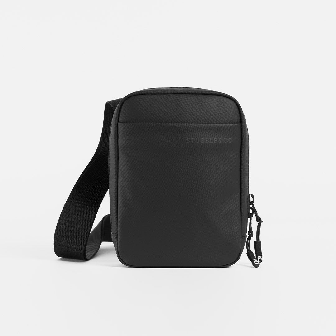 A studio shot of the front of an All Black shoulder bag