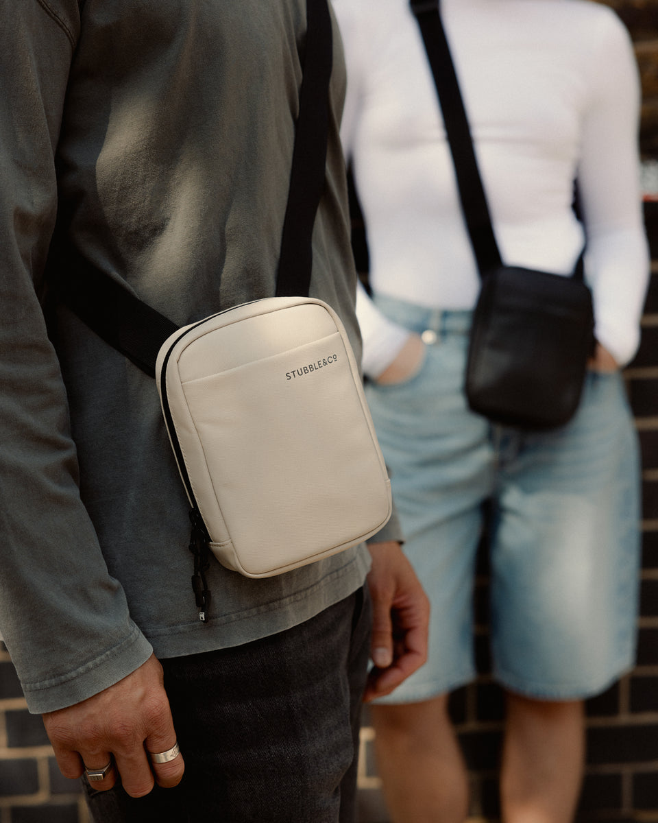 a close up of a sand shoulder bag on a man