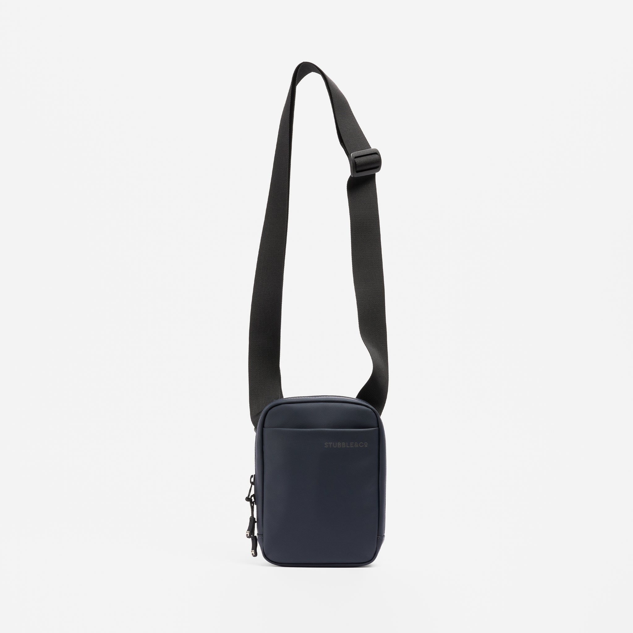 A studio shot of the Shoulder Bag in Midnight Blue hanging from the strap