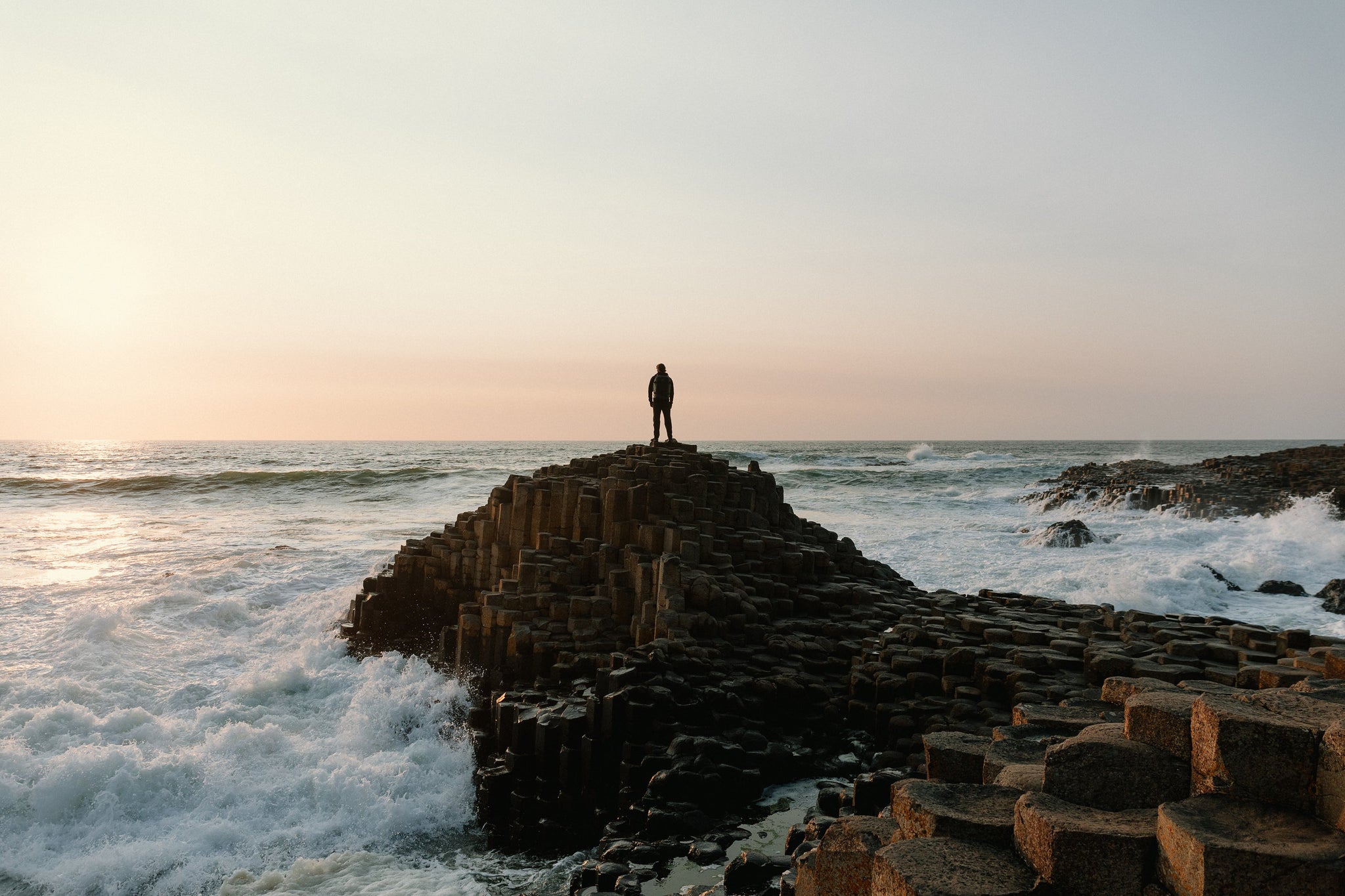 Man standing on coast line Northern Ireland