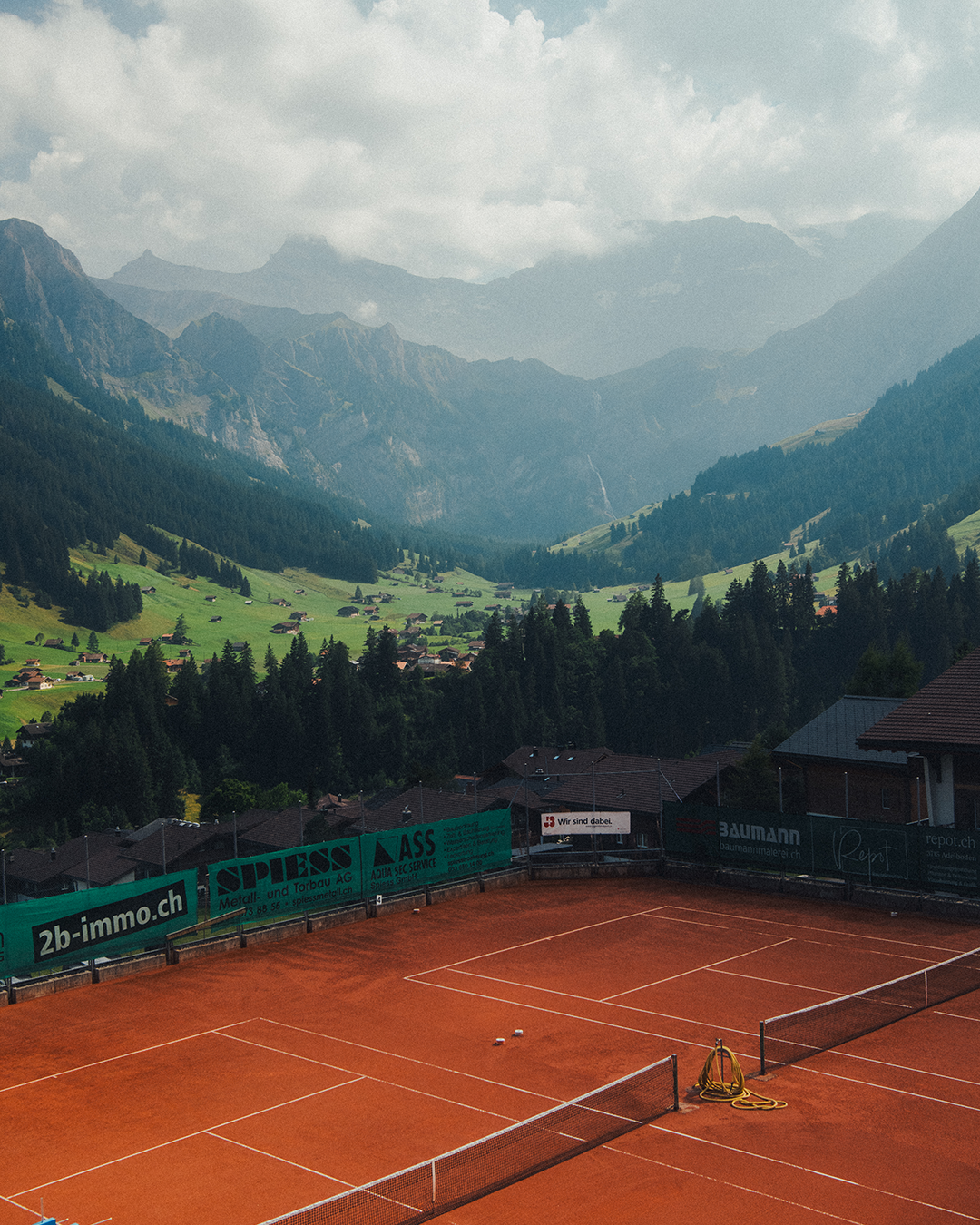 Bernese Oberland mountain landscape in Switzerland with tennis court in foreground