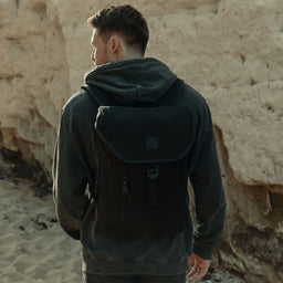 Man wearing The Backpack Mini in All Black