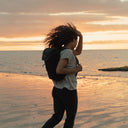 Women wearing The Backpack Mini in All Black at sunset