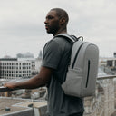 Man wearing The Everyday Backpack in Concrete