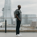 Man wearing The Everyday Backpack in Concrete