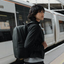 Women with All Black Everyday Backpack by a train