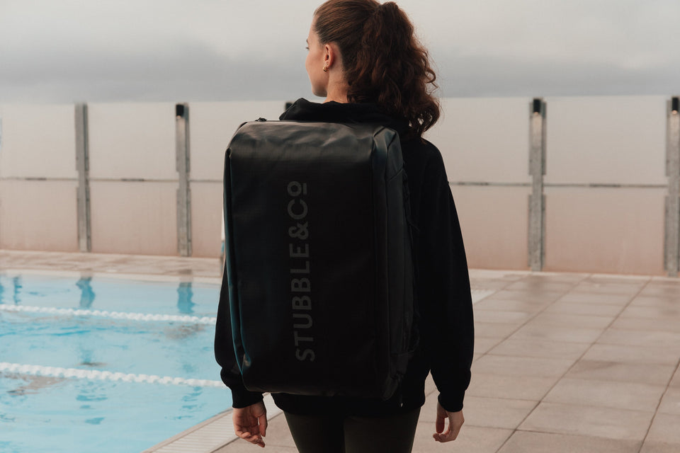 Women wearing The Kit Bag by a swimming pool