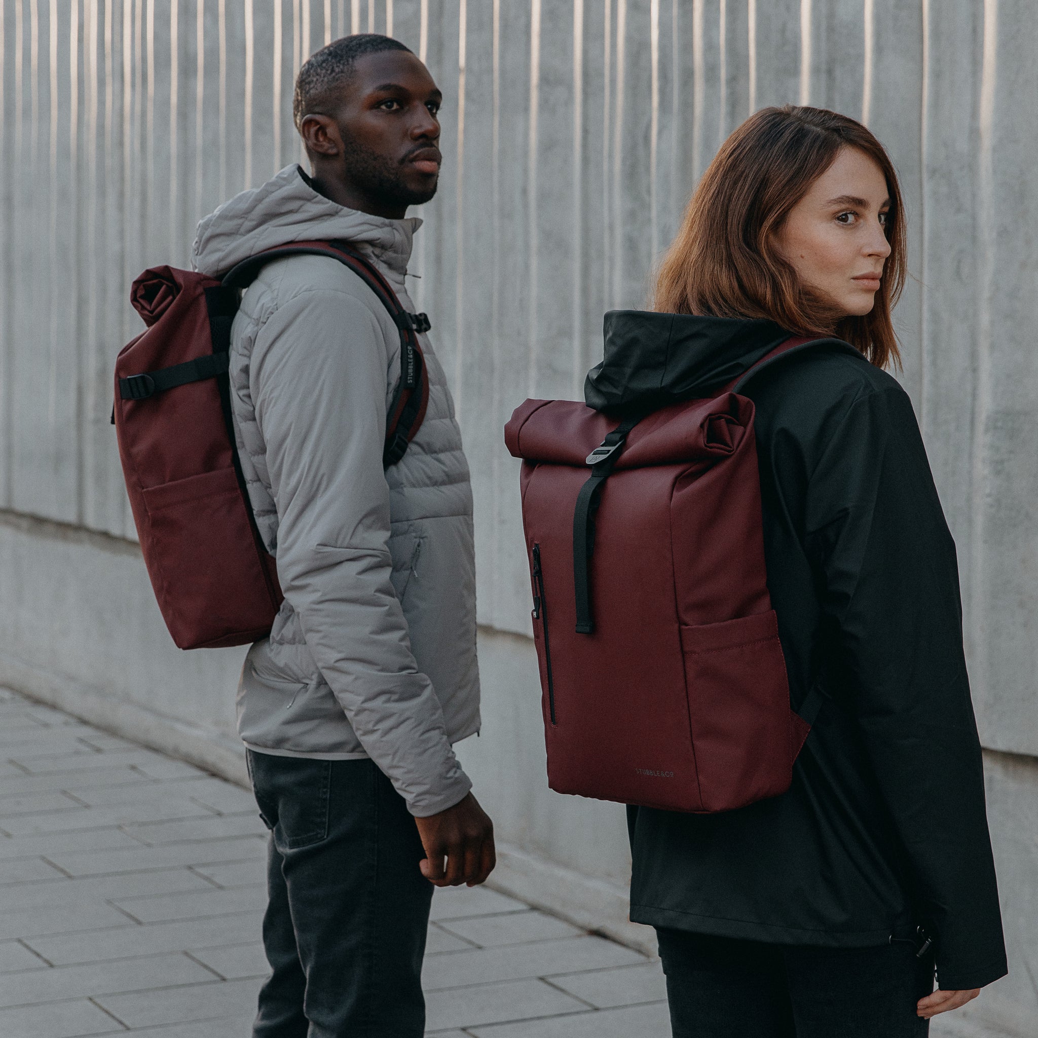 Man and women wearing Roll Top Mini in Earth Red