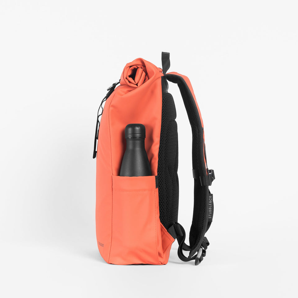 a studio shot of the bottle pocket on an Ember Orange roll top mini