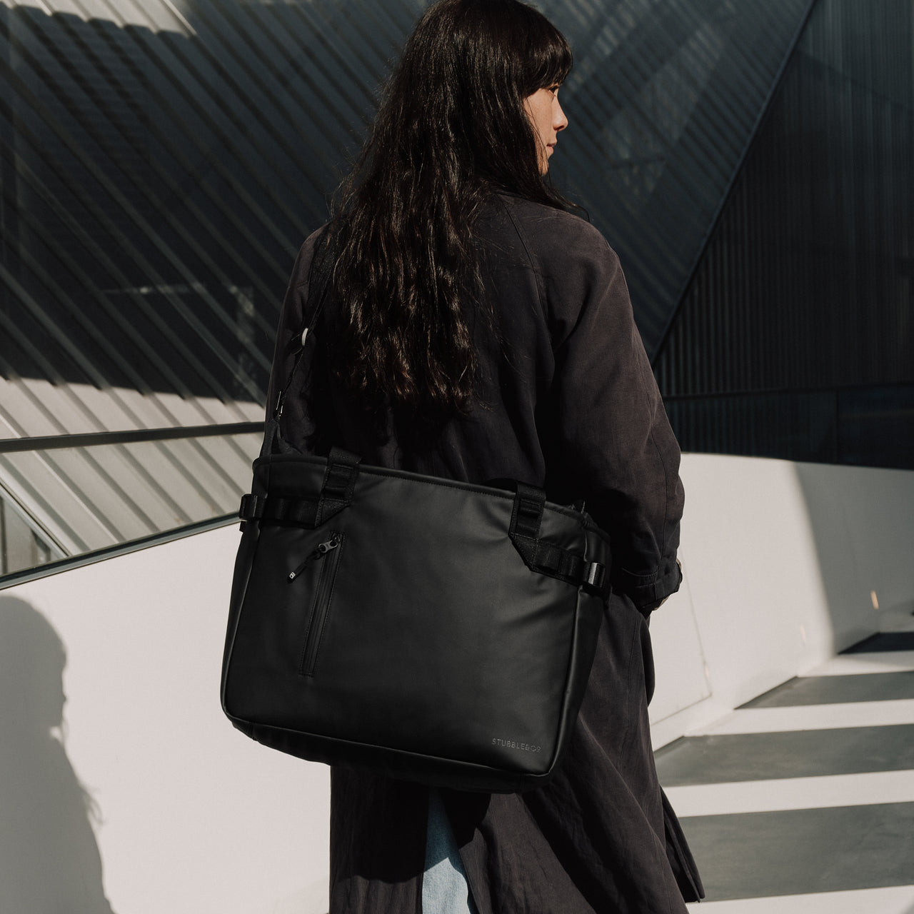 Female carrying The Tote Bag in All Black