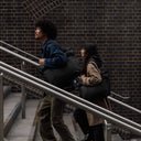 People carrying The Tote Bag in All Black and walking up steps