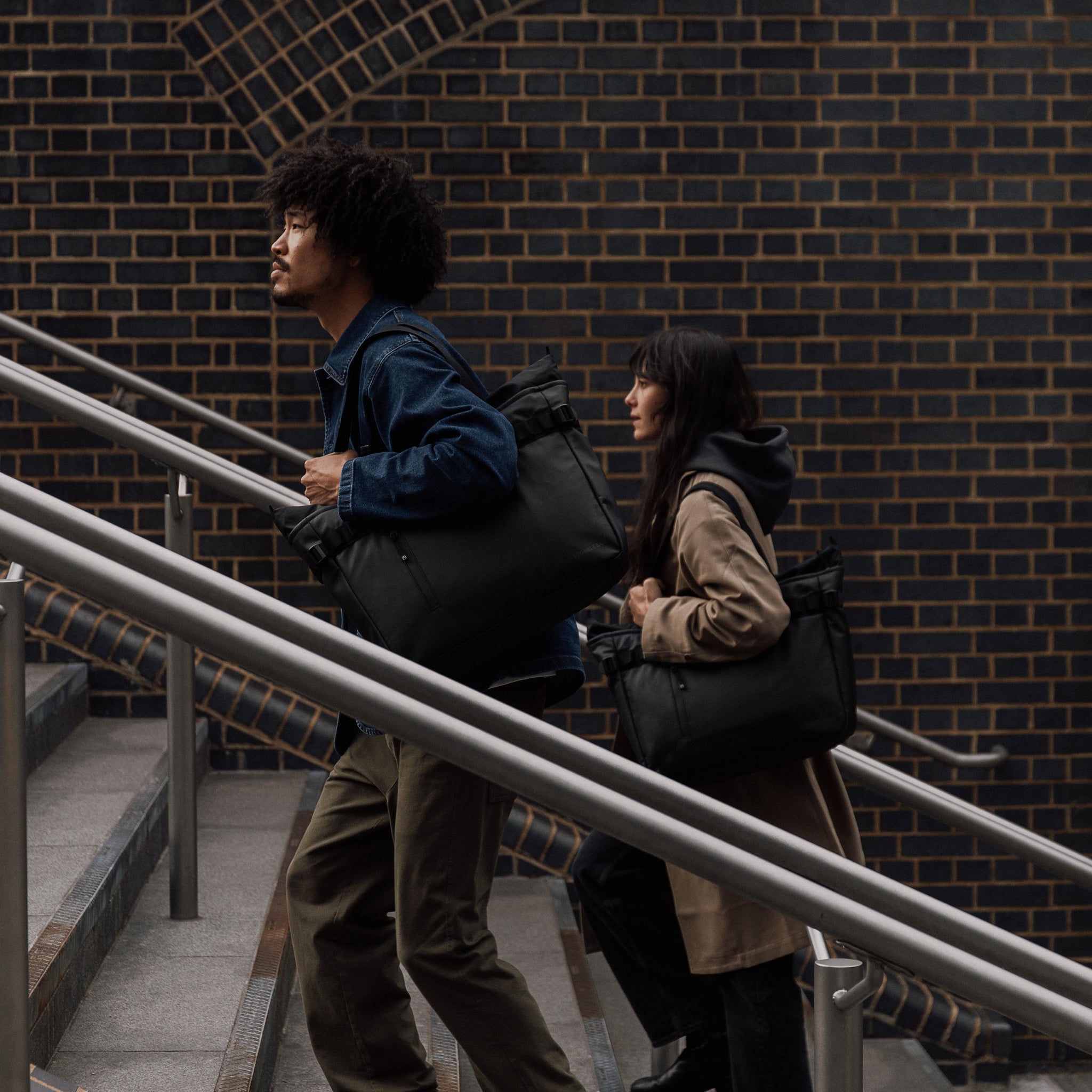 People carrying The Tote Bag in All Black and walking up steps