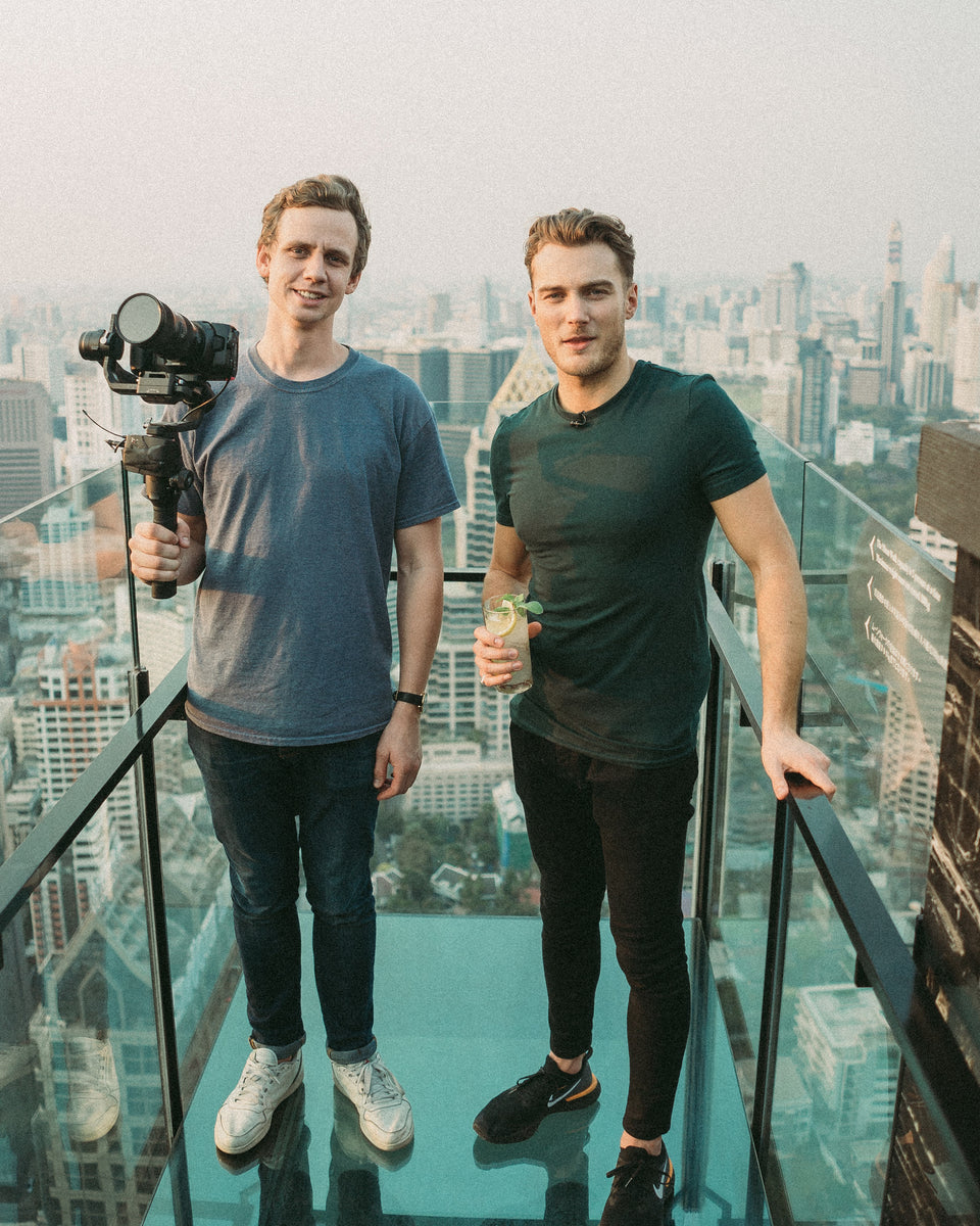 The Youtubers TopJaw standing on a rooftop bar in Bangkok