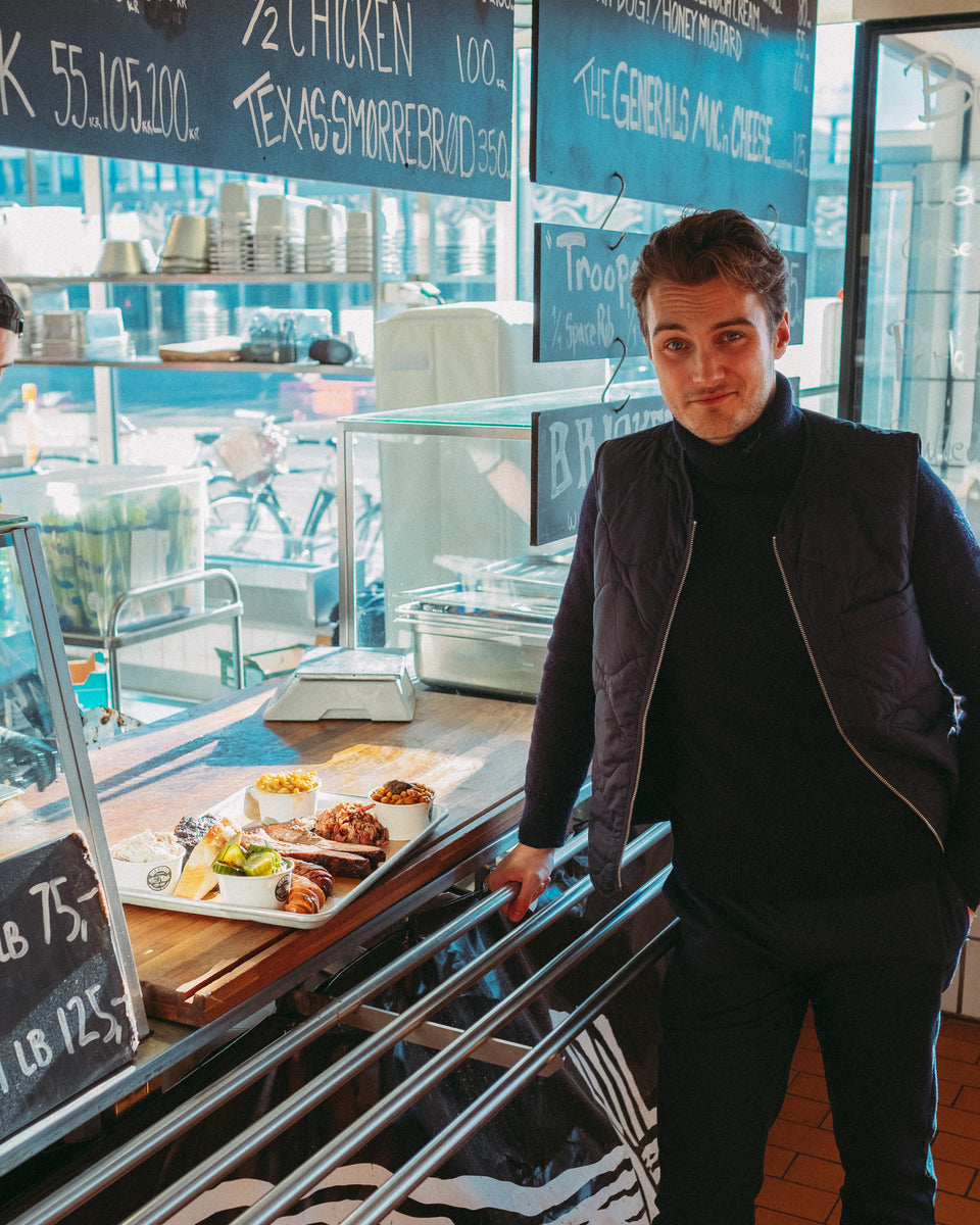 A man standing at a food counter with his tray of food