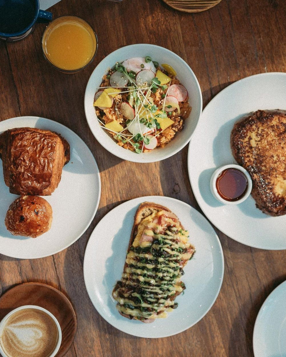A shot of Brunch food on a table, including pastries