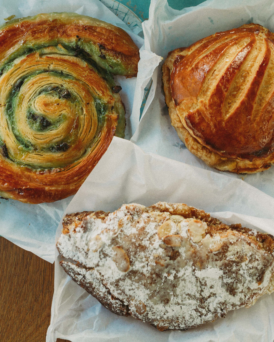 A shot of fresh pastries including an almond croissants