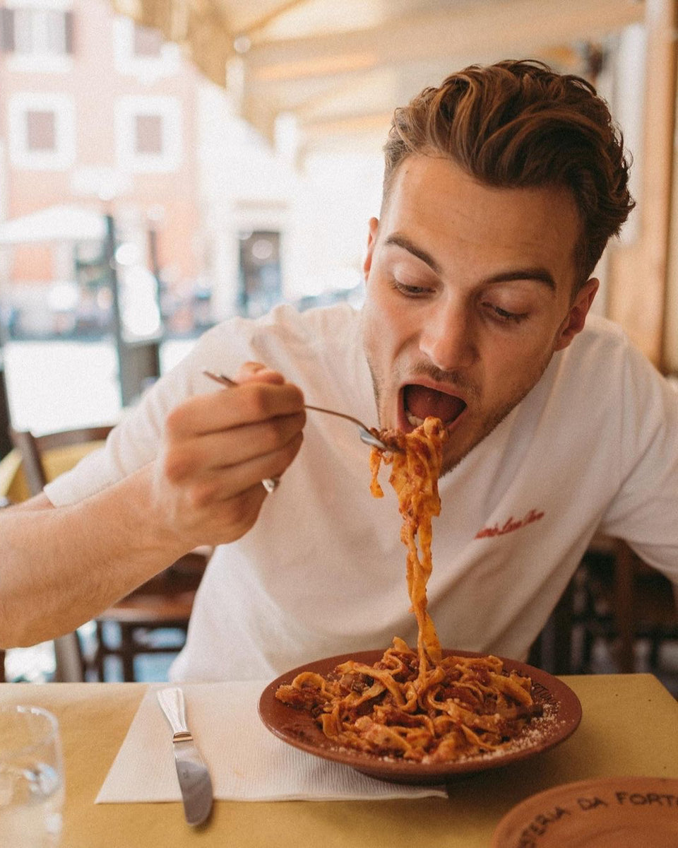 A man from the Youtubers TopJaw eating tomato spaghetti