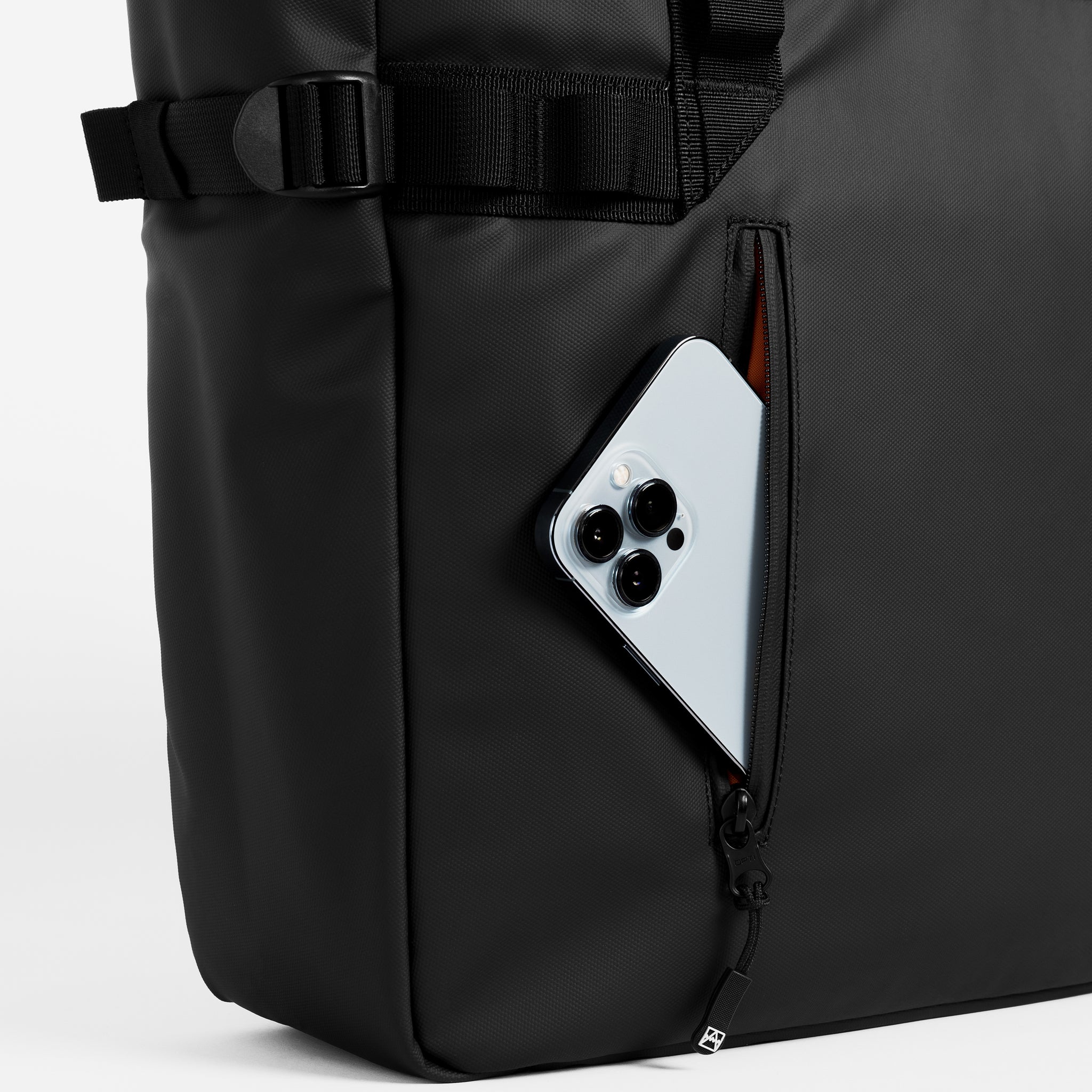 A tote bag in All Black and a close up of the front zip compartment with a phone in it