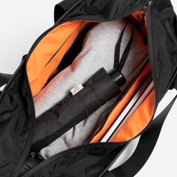 A studio shot of the Tote Bag in All Black  packed using it's interior organisation