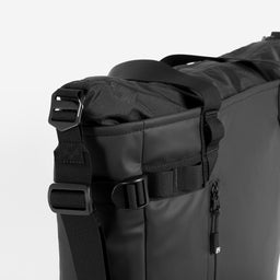 The Tote Bag in All Black and a close up of the secure top zip
