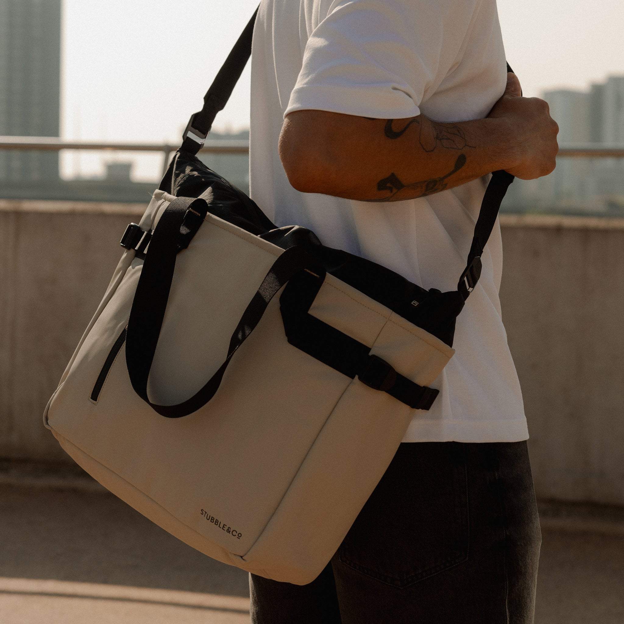 A close up shot of a Sand Tote Bag on a mans shoulder using a longer strap