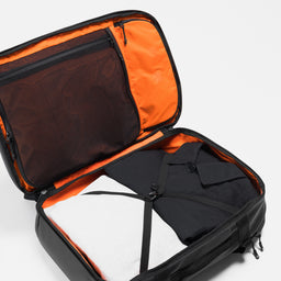 A studio shot of the clamshell packing of the Travel Backpack 40L in All Black