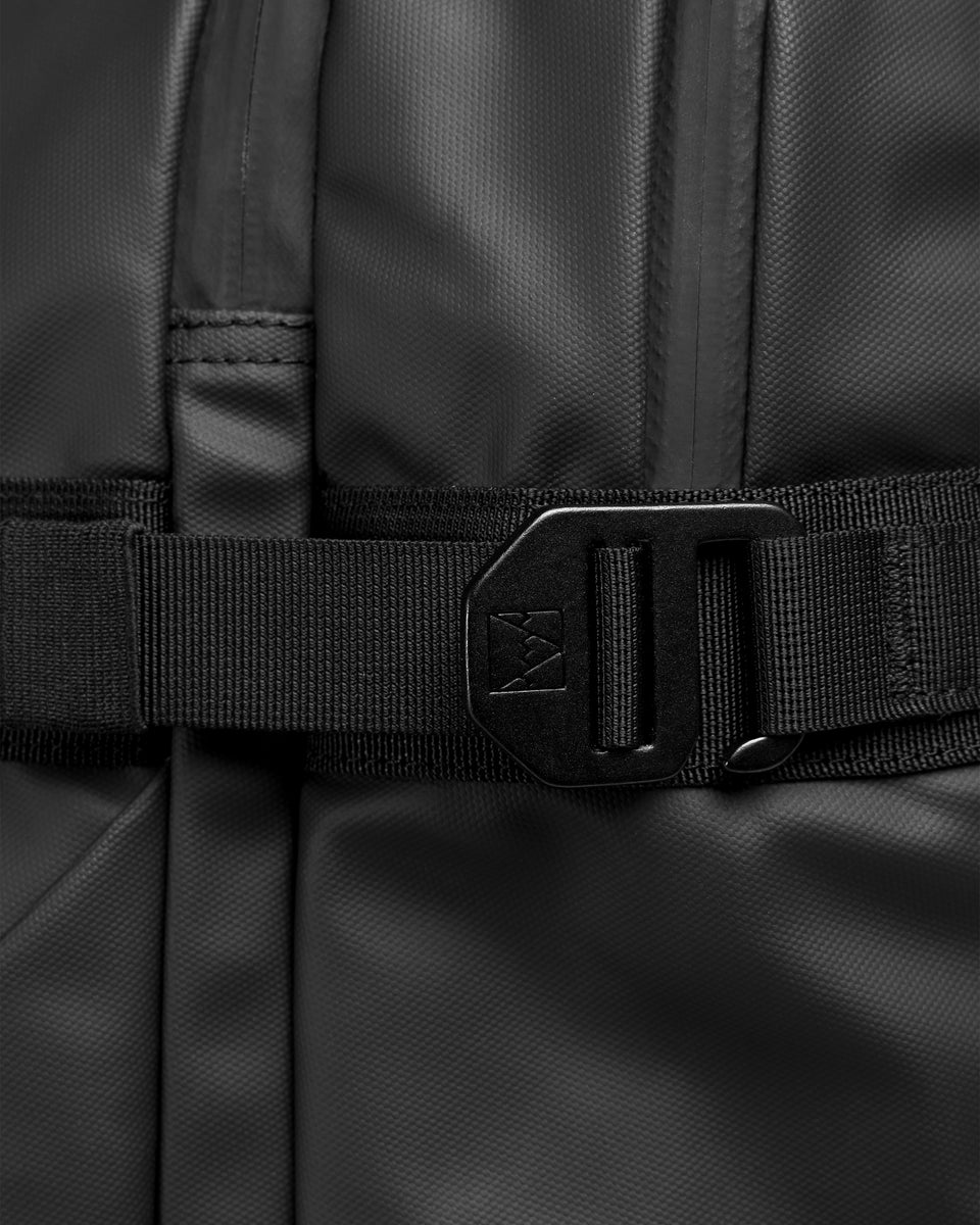 A studio shot showing the compression straps on the travel backpack 40l