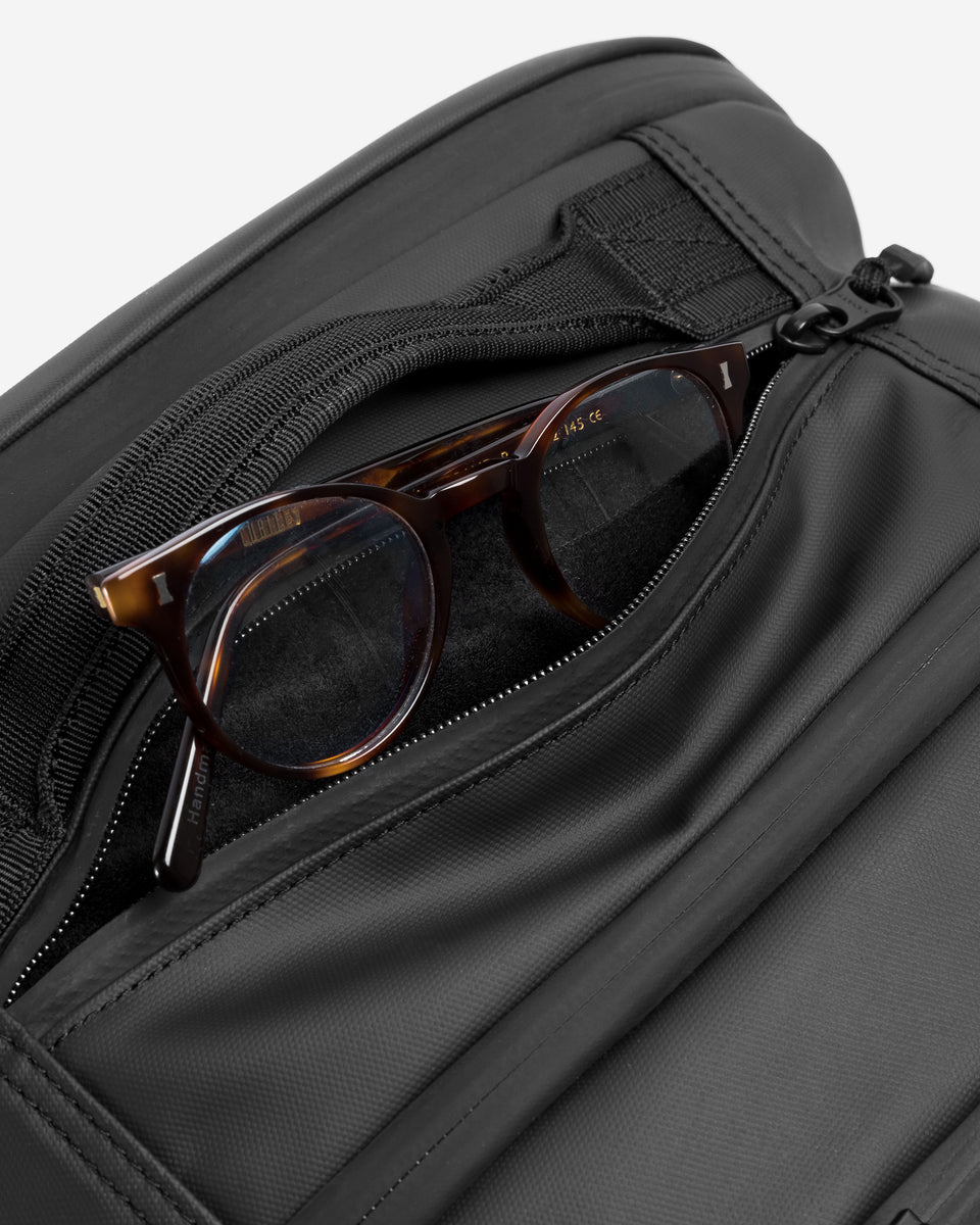 A studio shot showing the top soft lined pocket of the travel backpack 40l