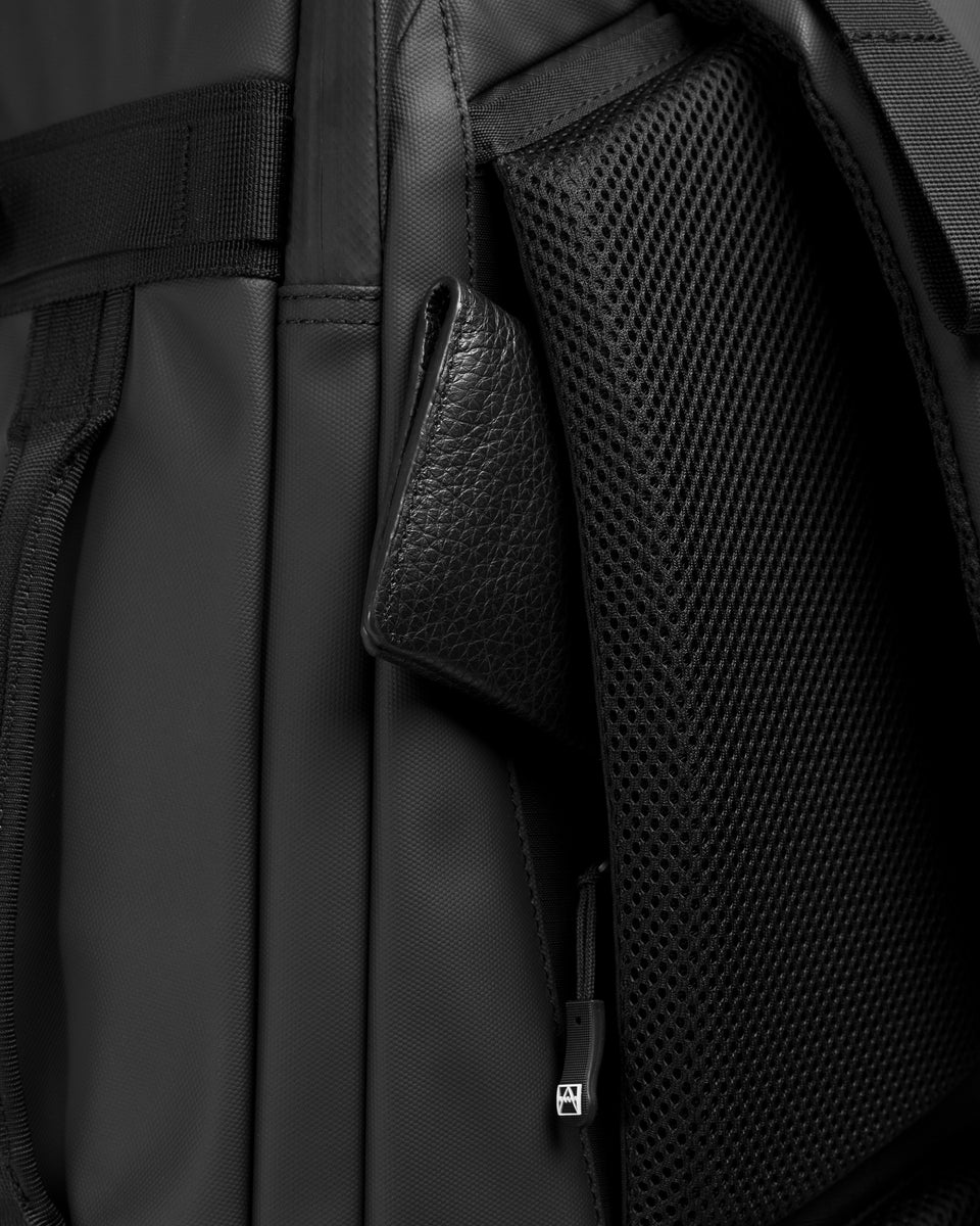 A studio shot showing the hidden pocket on the travel backpack 40l