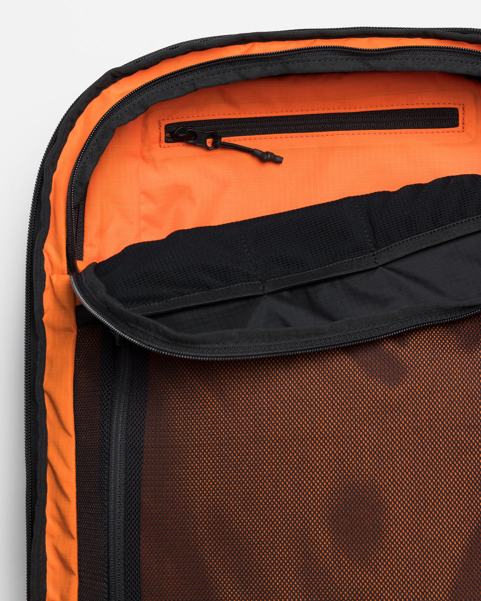 a studio shot showing the dual access pocket on the travel backpack 40l
