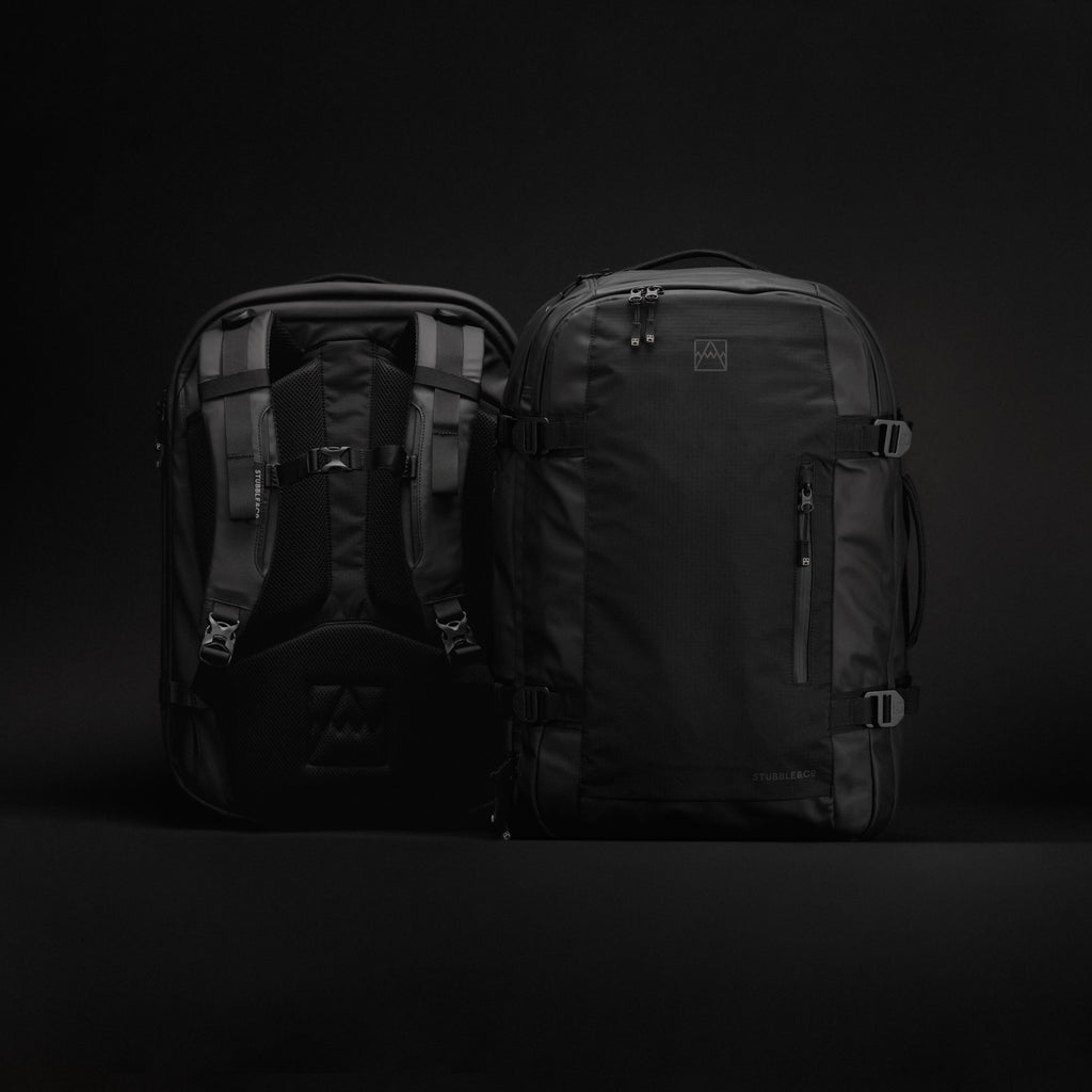 a studio shot of the two travel backpack 40l side by side showing the front and back panel