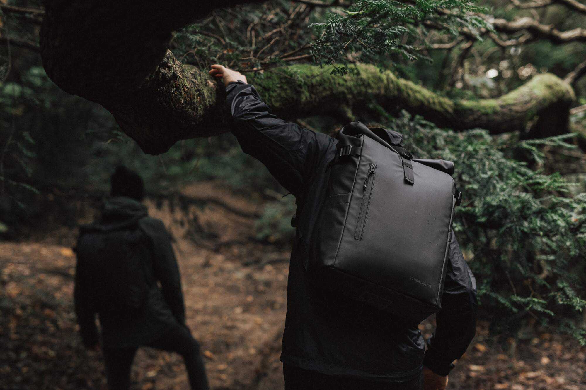 Two men hiking in the forest with a Roll Top bag 