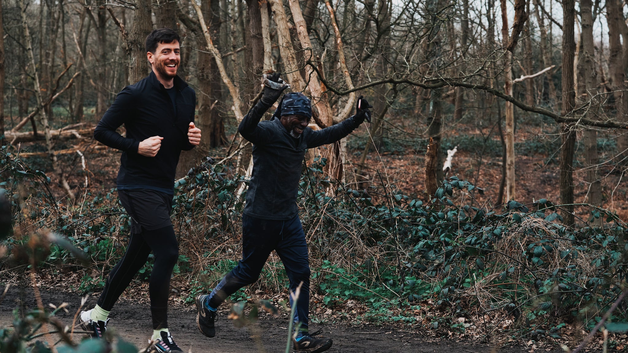Two men running through the forest