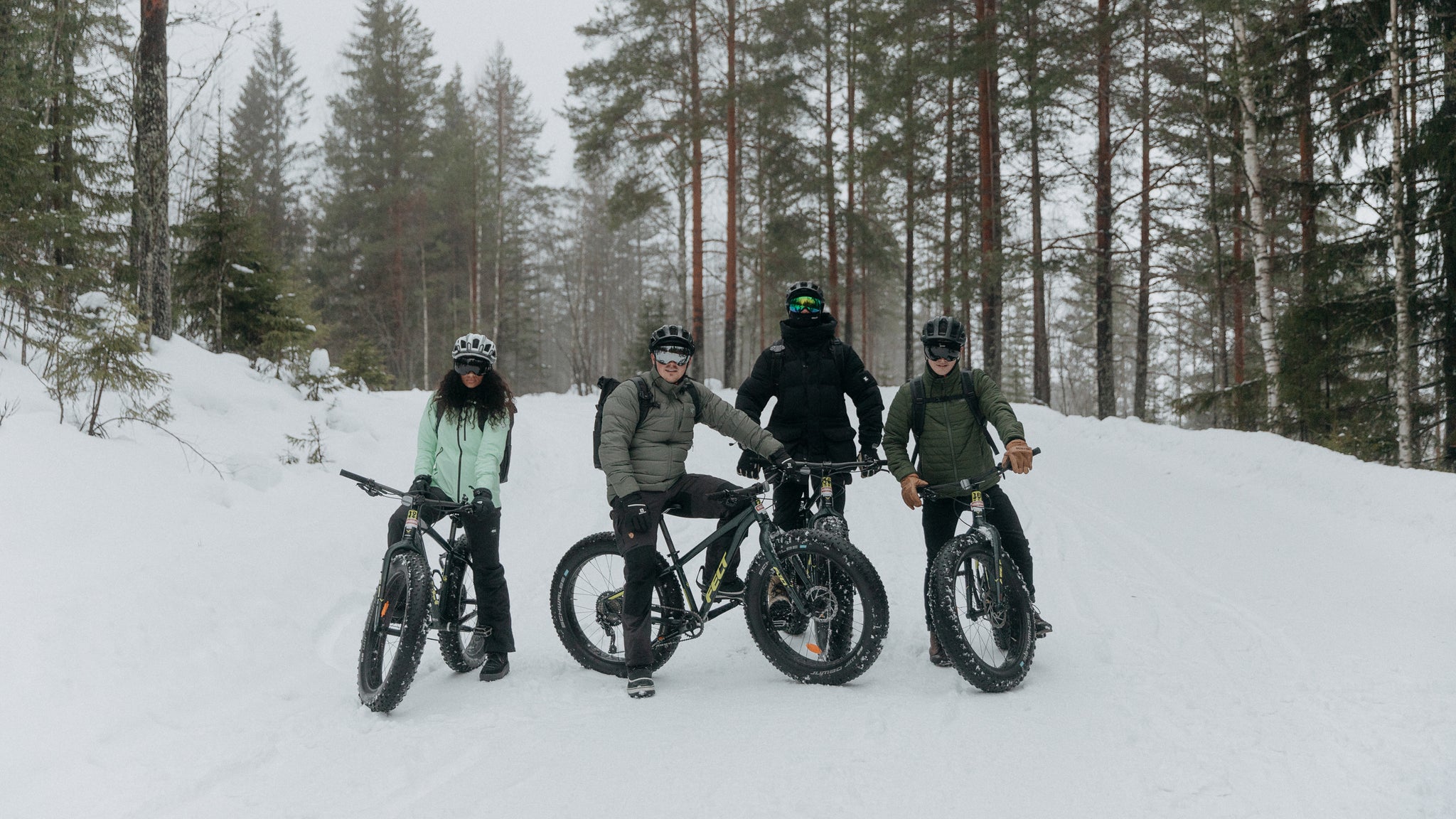 People on snow bikes in Finland with their Stubble & Co bags on their backs