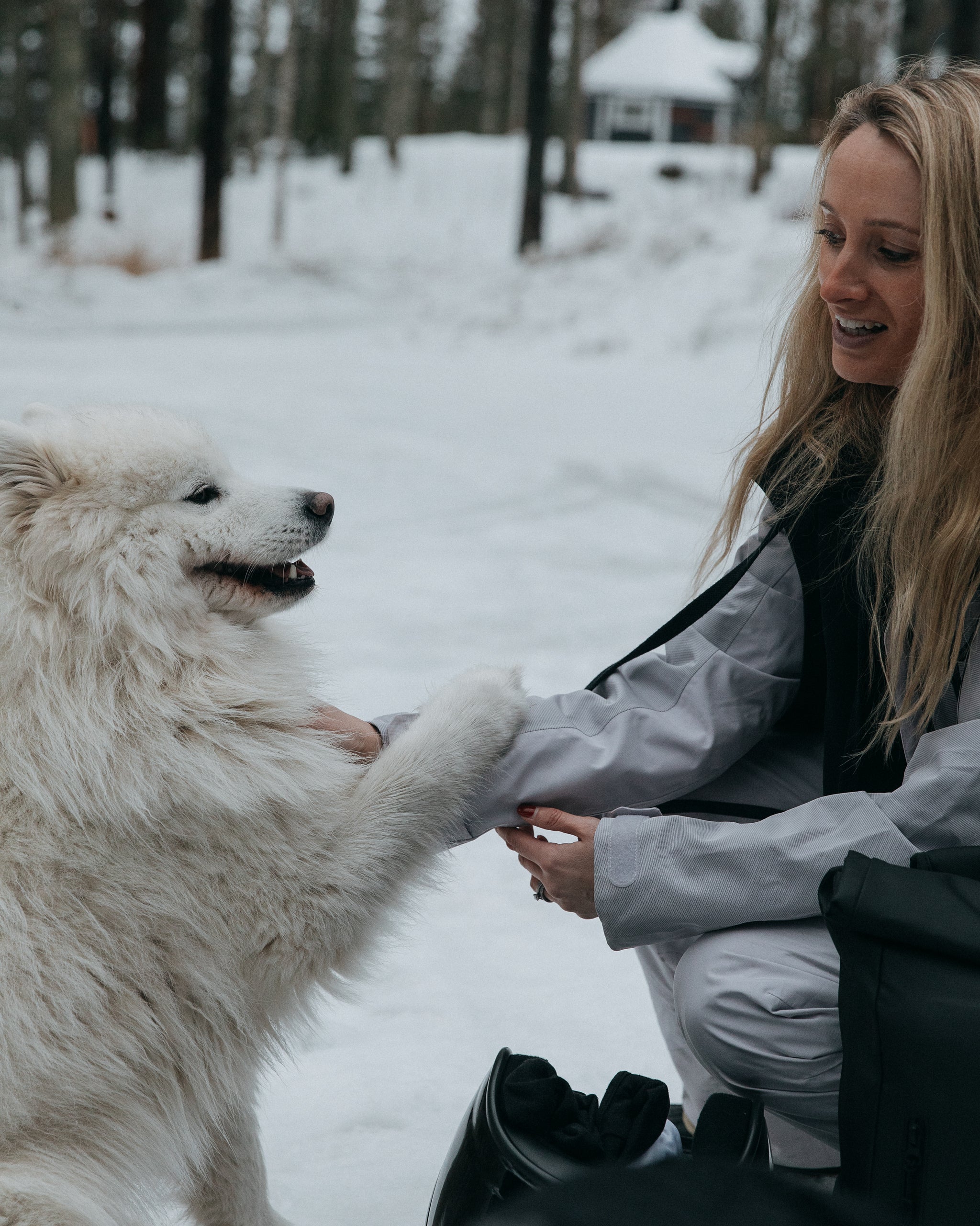 A woman with a snow dog in Finland