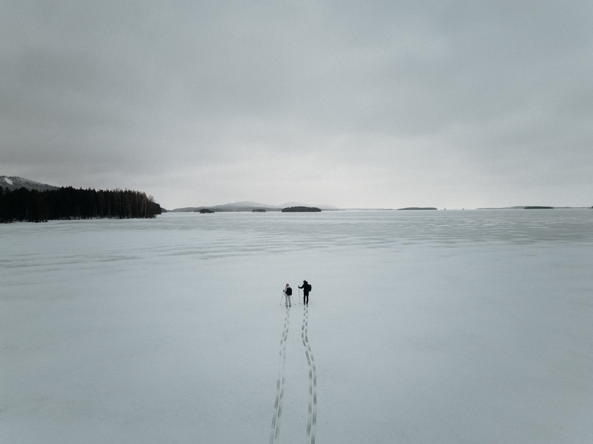 Two people walking in snowy Finland