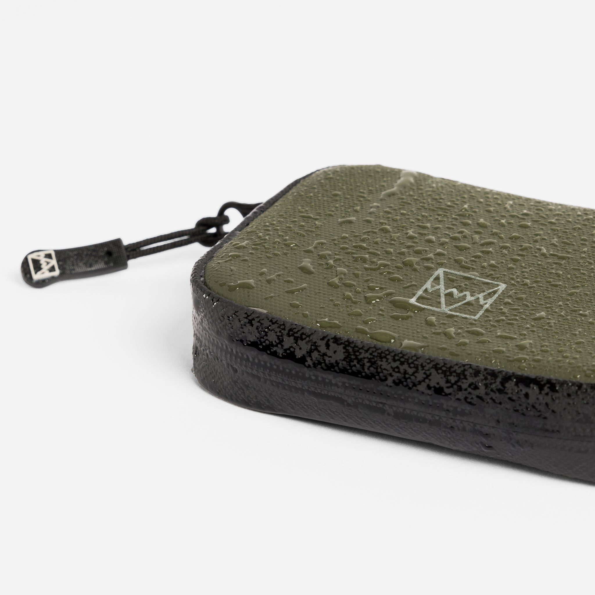 A studio shot of the waterproof materials on the wallet in Urban Green