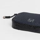 A studio shot of the waterproof materials on the wallet in Midnight Blue