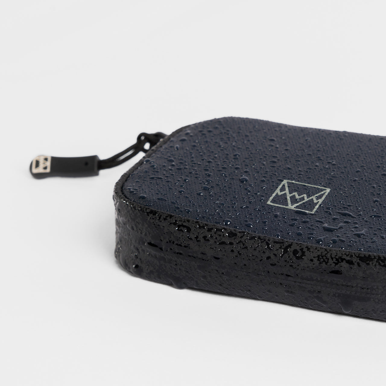 A studio shot of the waterproof materials on the wallet in Midnight Blue