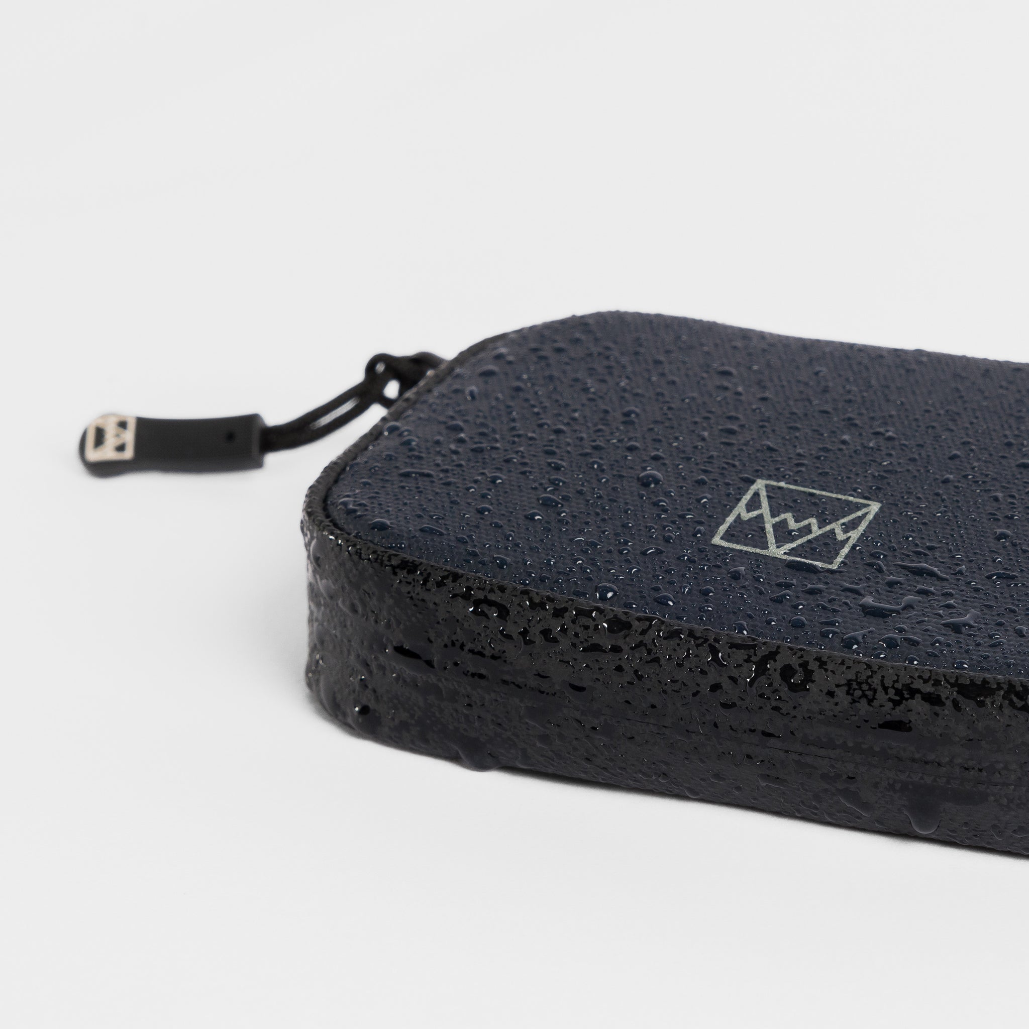 A studio shot of the waterproof materials on the wallet in Midnight Blue