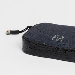 A studio shot of the waterproof materials on the wallet in Midnight Blue