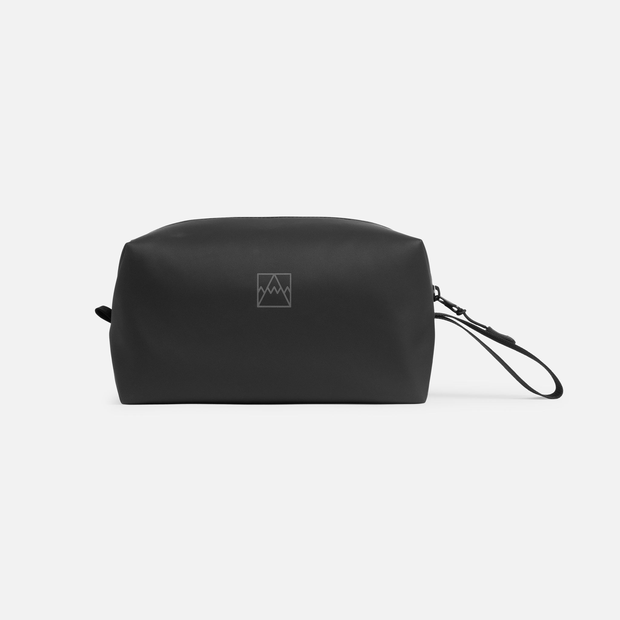 A studio shot of the front of the All Black wash bag with the reflective logo on show