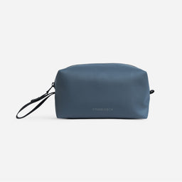 A studio shot of the back of the Tasmin Blue Wash Bag showing the reflective logo