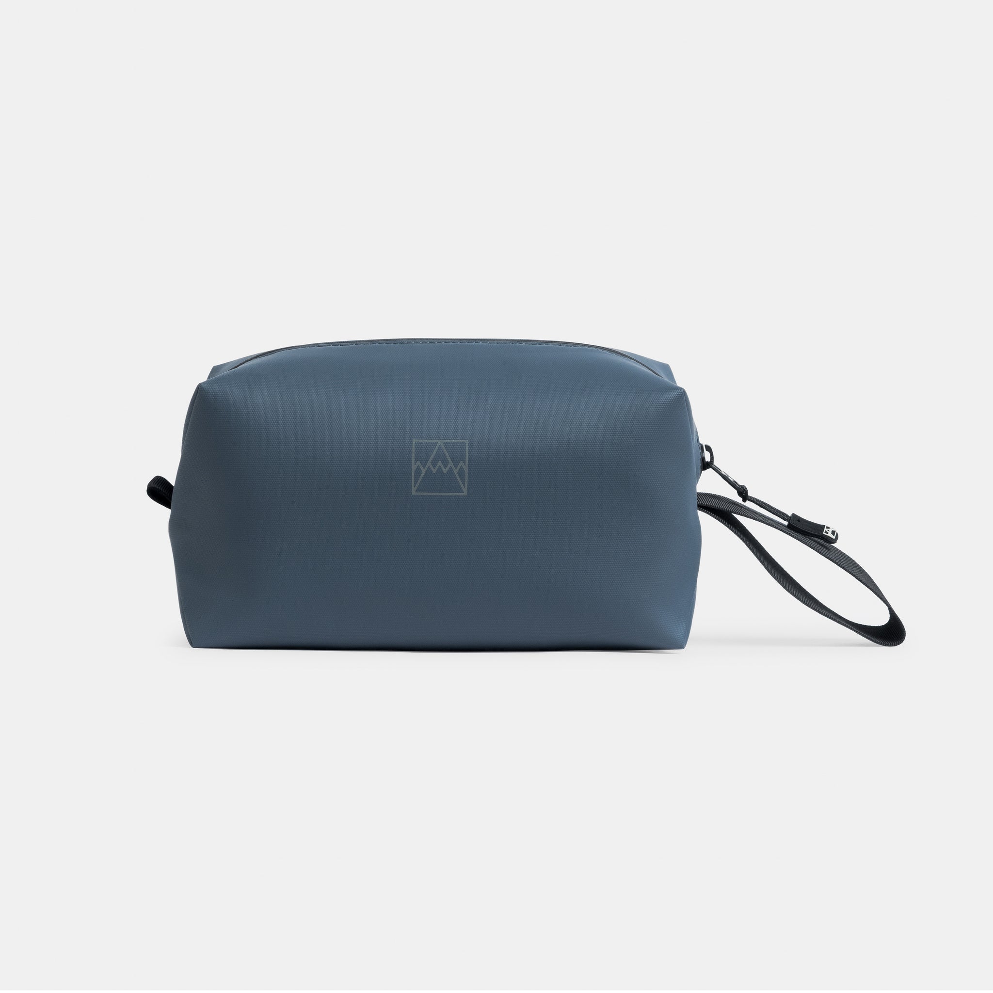 A studio shot of the front and reflective logo on the Tasmin Blue Wash Bag