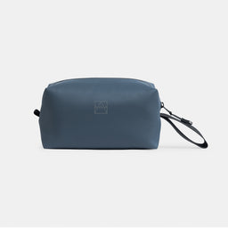 A studio shot of the front and reflective logo on the Tasmin Blue Wash Bag