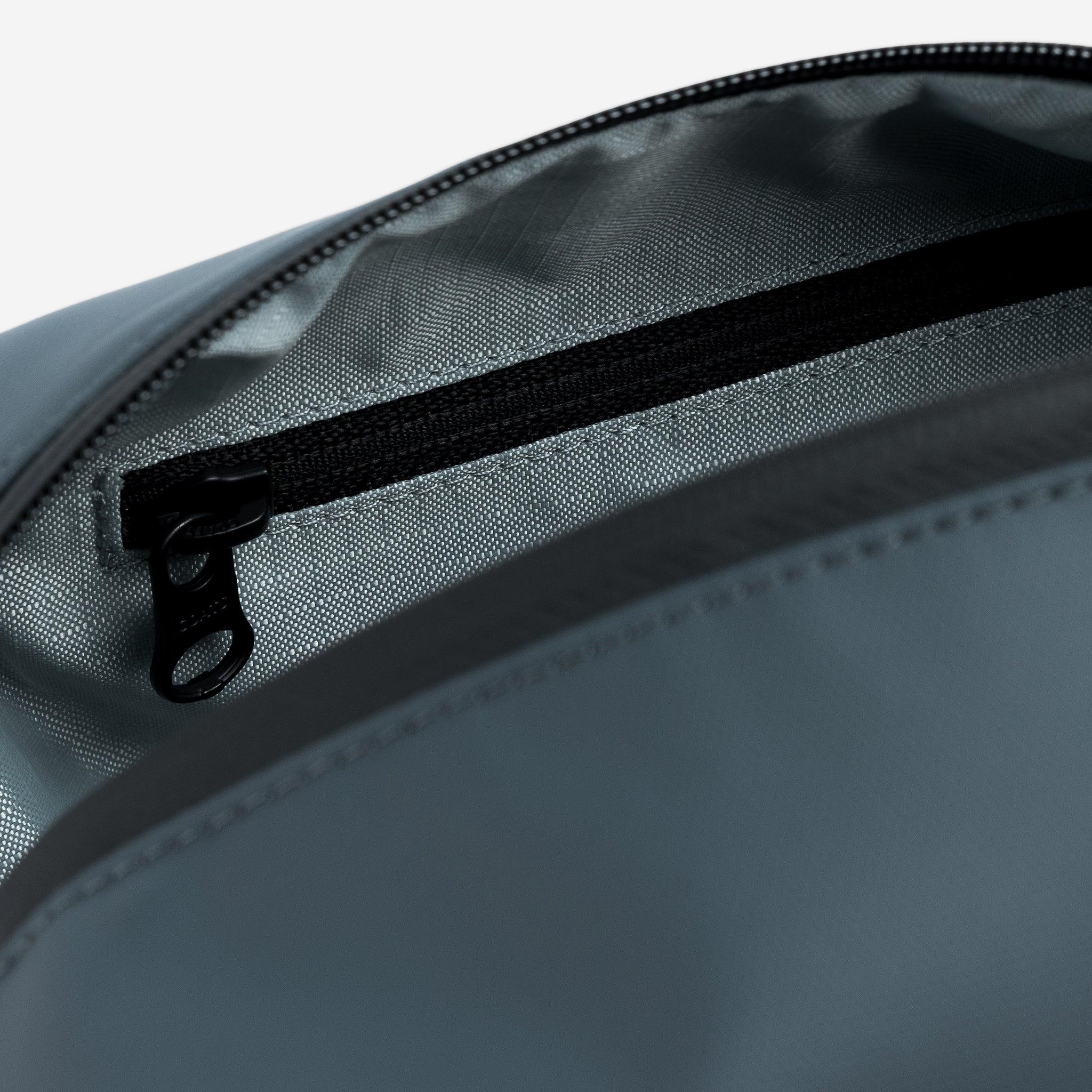 A close up studio shot of the interior pearl lining within the Tasmin Blue Wash Bag
