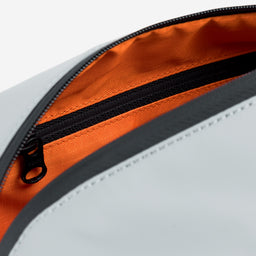 Astudio shot of the interior orange lining on the Concrete Wash Bag 