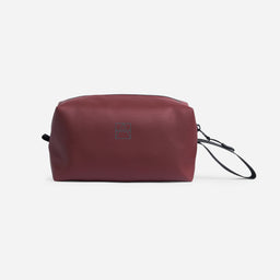 A studio shot of the front of the Garnet Red wash bag with the reflective logo