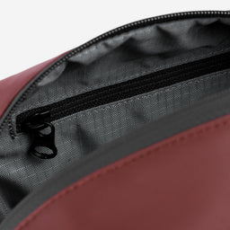 A studio shot of the interior of the Wash Bag in Garnet Red