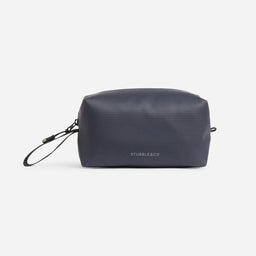 A studio shot of the back and reflective logo on the Midnight Blue Wash Bag